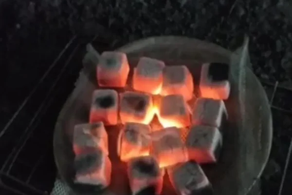 R Red cube charcoal briquettes burning evenly during a heat quality test.